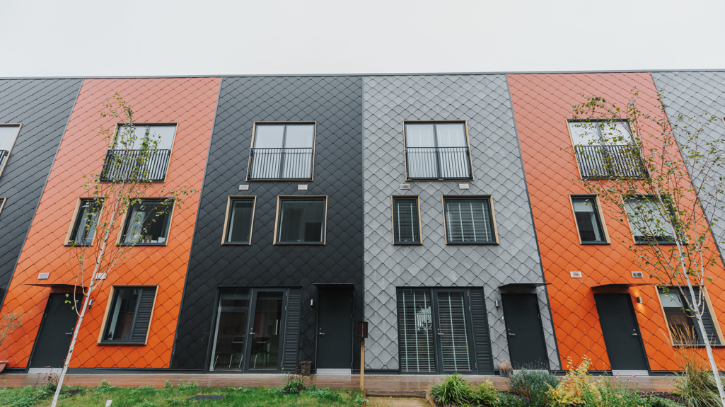 A row of multi-coloured terraced homes at the Climate Innovation District in Leeds.