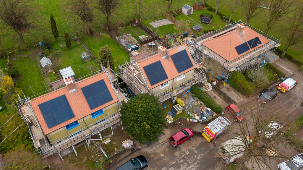 An aerial photograph of some new houses being built with solar panels on the roof. 