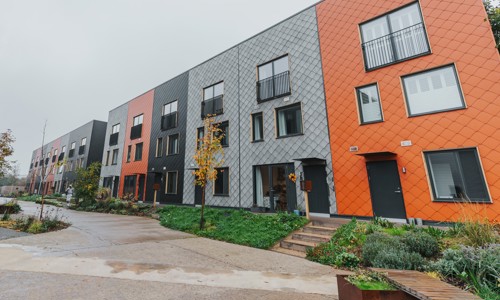 A row of multi-coloured terraced homes at the Climate Innovation District in Leeds.