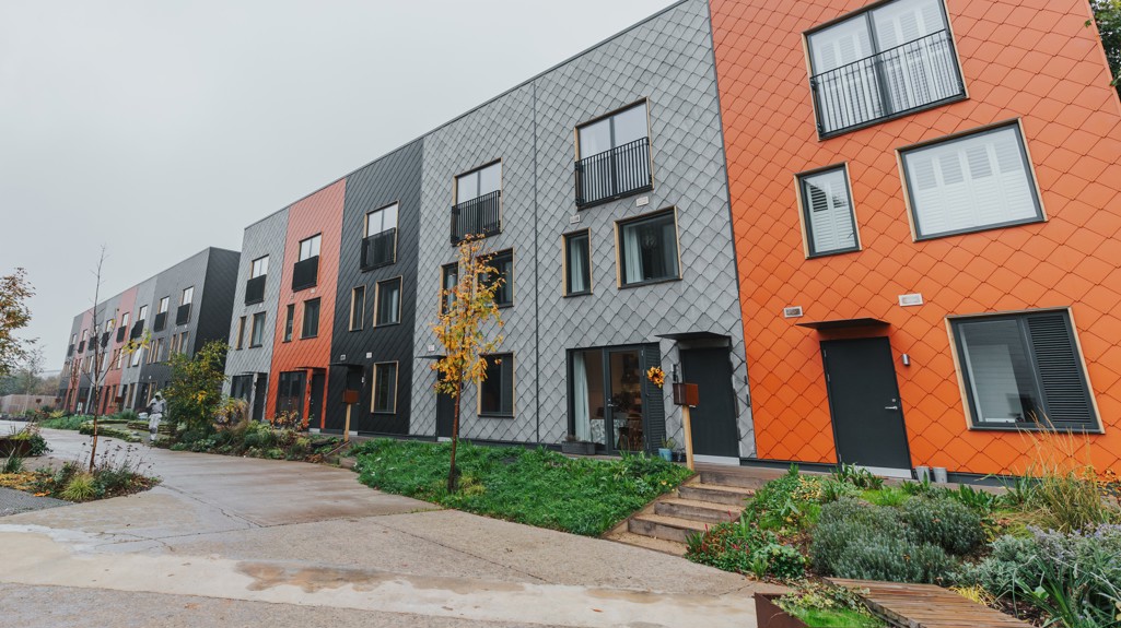 A row of multi-coloured terraced homes at the Climate Innovation District in Leeds.