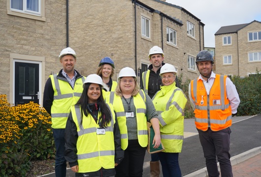 Yorkshire Housing, Equans and Calderdale Council colleagues pictured together at the Cromwell Gardens development in Rastrick. 