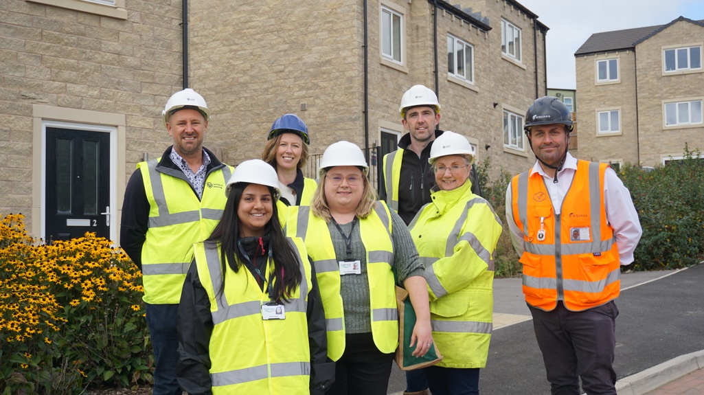 Yorkshire Housing, Equans and Calderdale Council colleagues pictured together at the Cromwell Gardens development in Rastrick. 