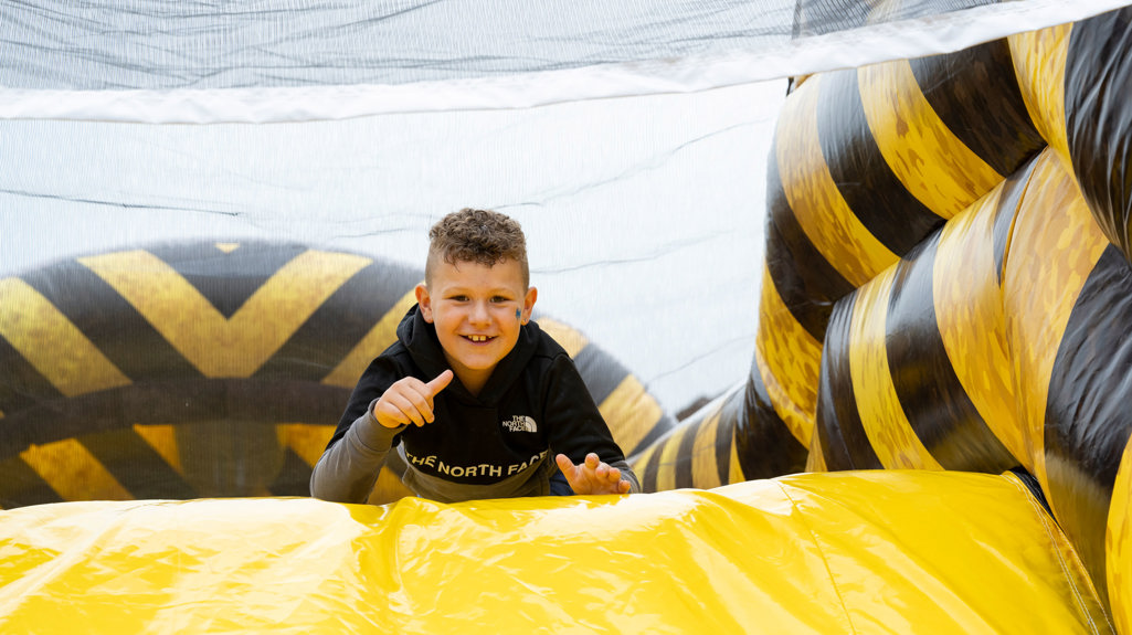 Boy smiling while on an yellow obstacle course