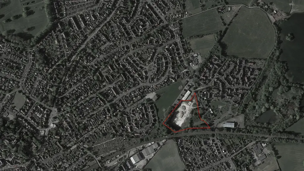 Aerial view showing an area for development of new homes outlined in red