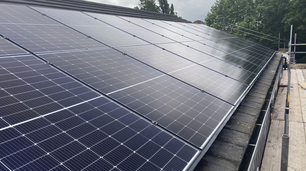 Photo shows a close up view of solar panels on a roof 